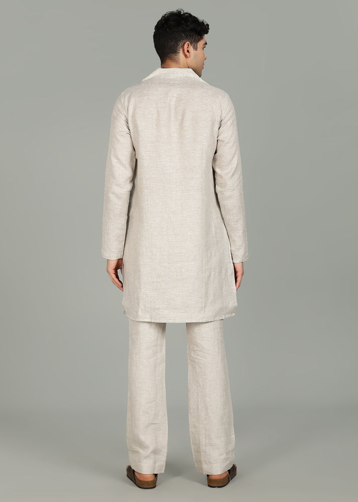 Man wearing a 100% pure linen Ecru Kurta, in a grey background indoor.