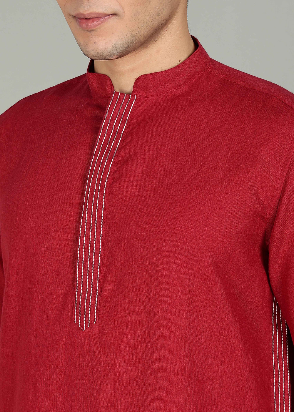 Man wearing a 100% pure linen mud red long kurta in 60 LEA with white detailing against a gray background