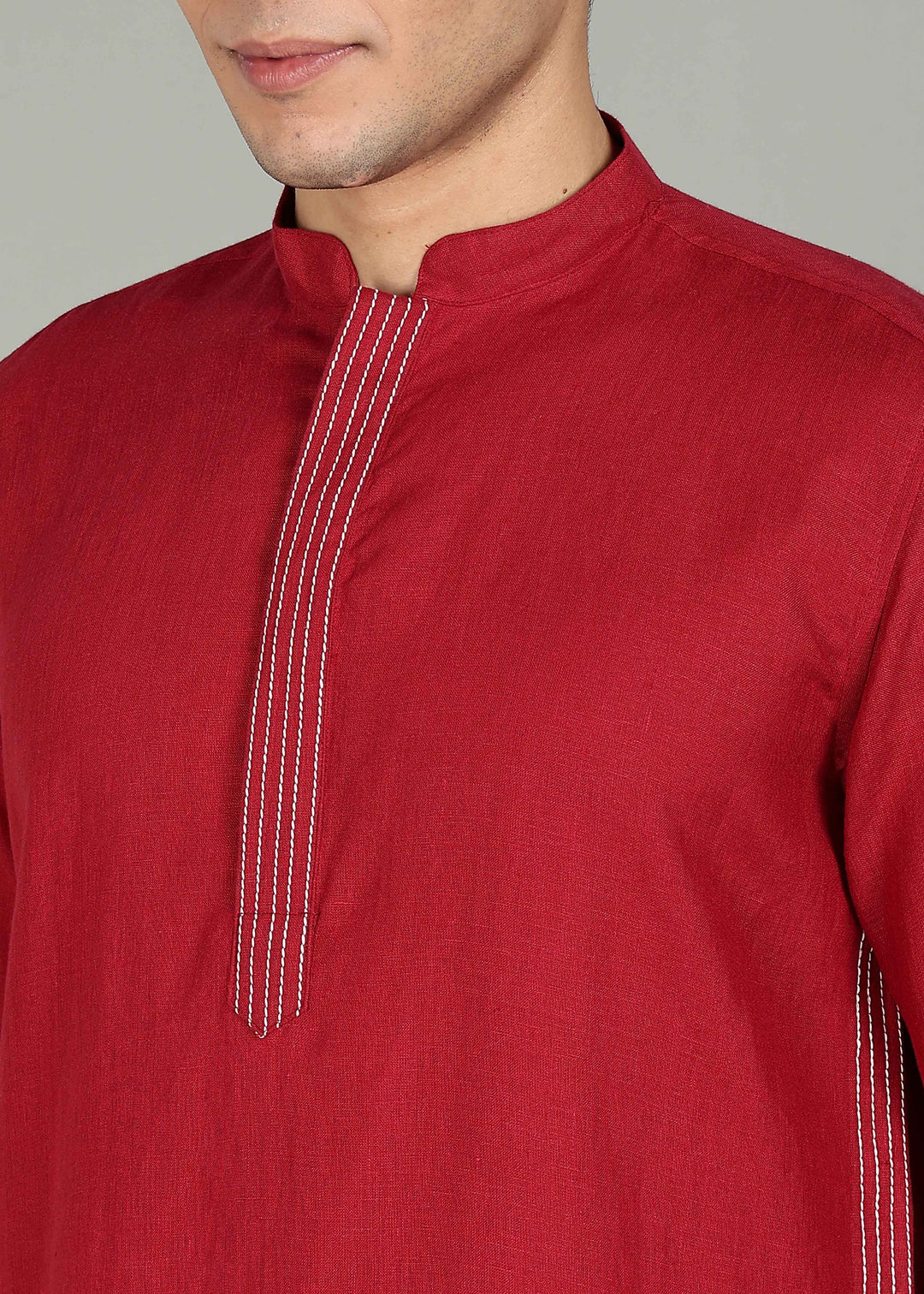 Man wearing a 100% pure linen mud red long kurta in 60 LEA with white detailing against a gray background