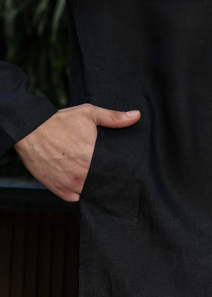 Man wearing a 100% pure linen black long kurta with pink floral design on the back in 60 LEA