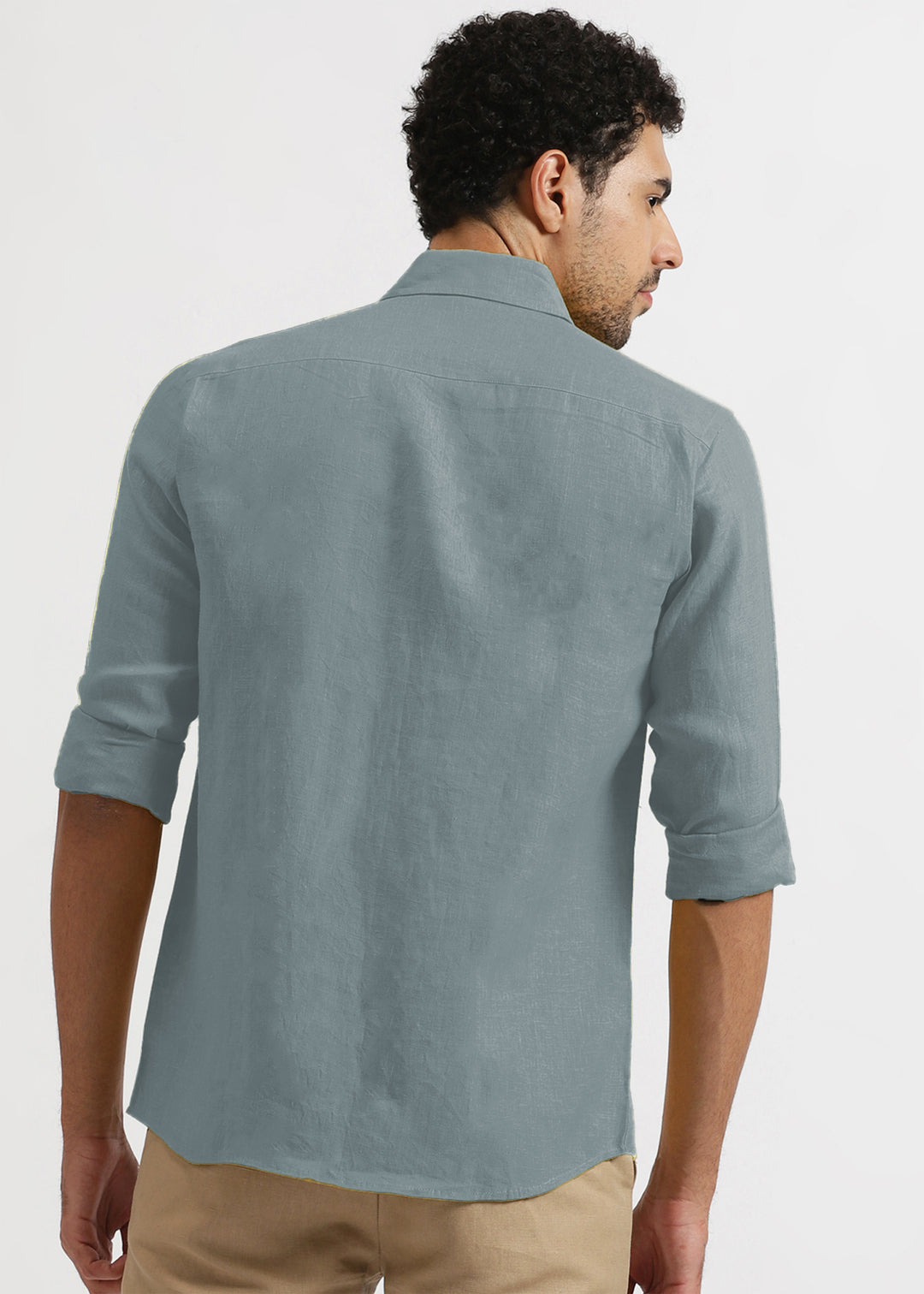 Man wearing a a 100% pure linen mineral grey shirt with rolled-up sleeves on a white background