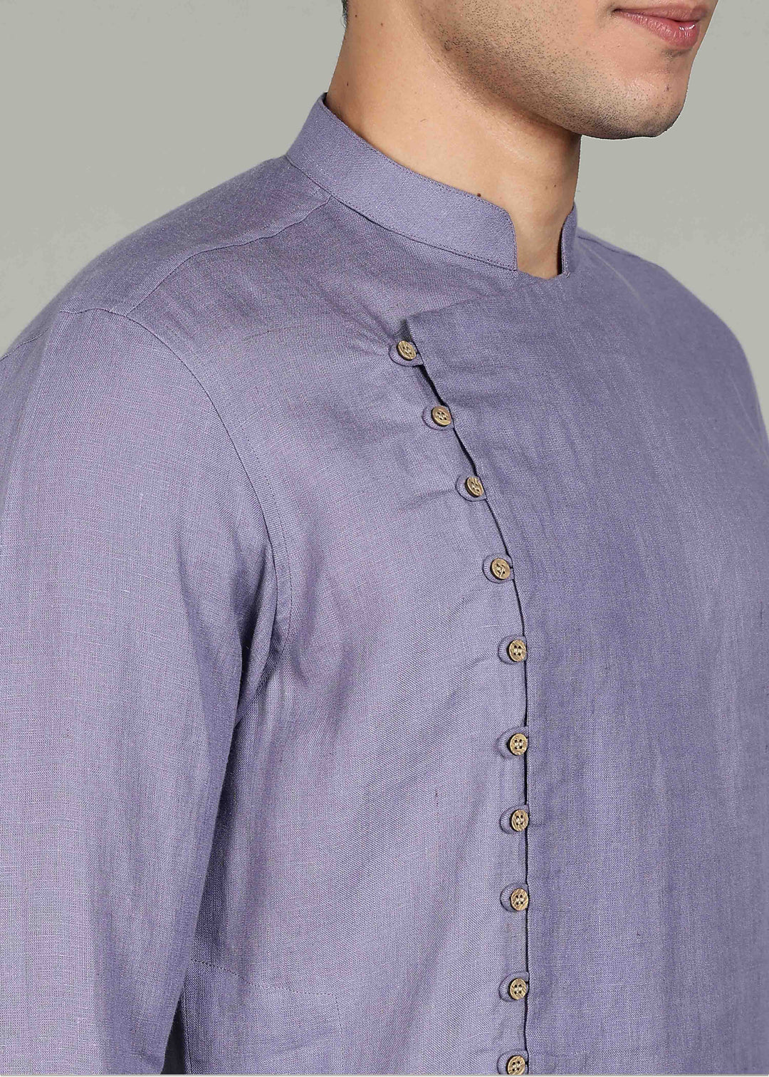 Man wearing a 100% Lavender violet 60 lea Kurta, with placket detail, in a Grey  Background indoor.