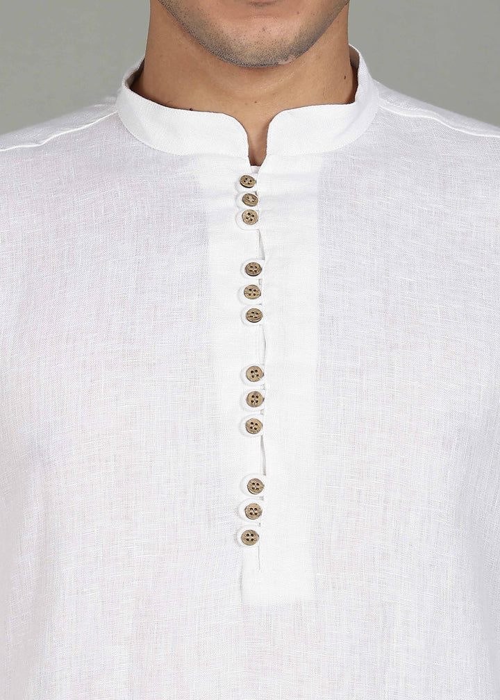 Man wearing a 100% pure linen white long kurta with pink floral design on the back in 44 LEA against a gray background