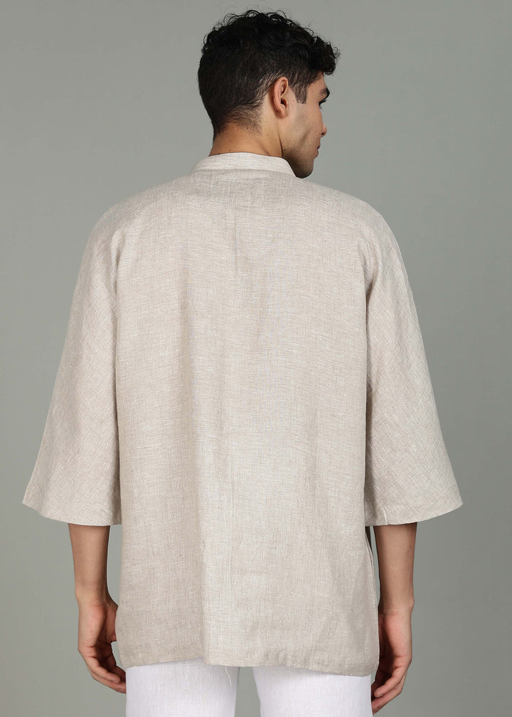 Man wearing a 100% pure linen ecru short kurta in 60 LEA with a gray background