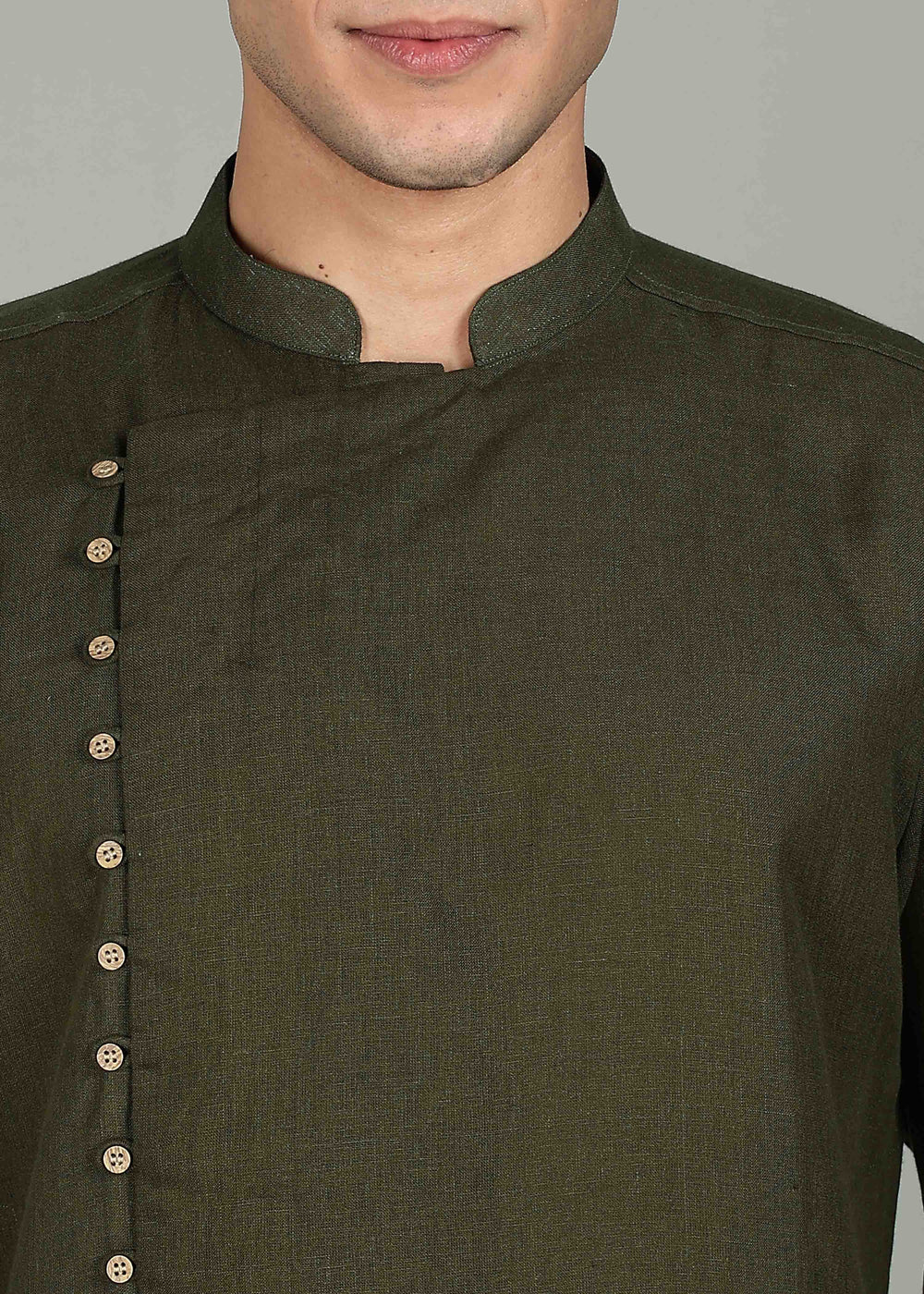 Man wearing a 100% Moss Green 60 lea Kurta, with placket detail, in a Grey  Background indoor.