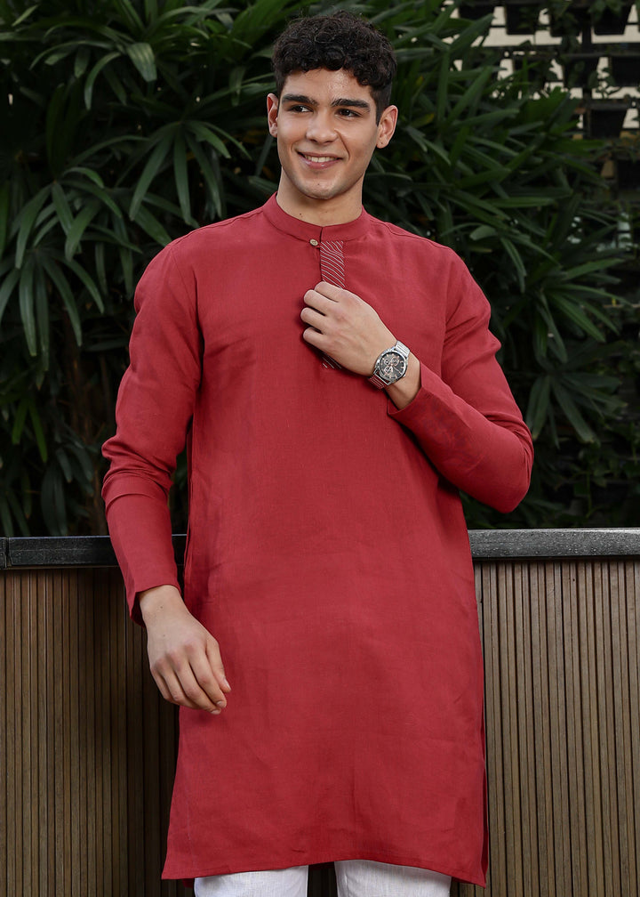Man wearing mud red Kurta, 100% pure linen, outdoor green background.