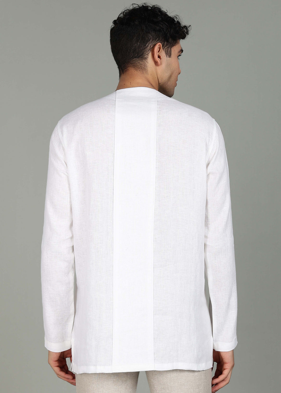 Man wearing a 100% pure linen white long-sleeve kurta in 44 LEA against a gray background