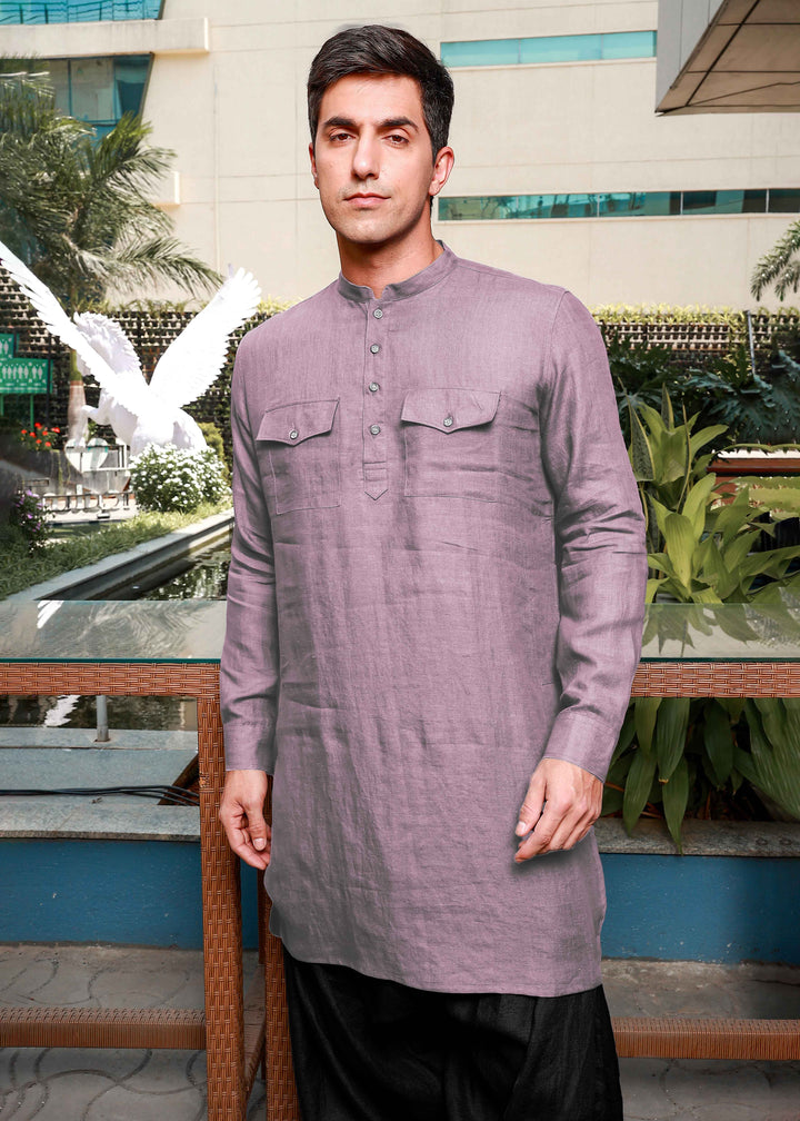 Man wearing a 100% pure linen cameo pink long kurta with black pants in an outdoor setting