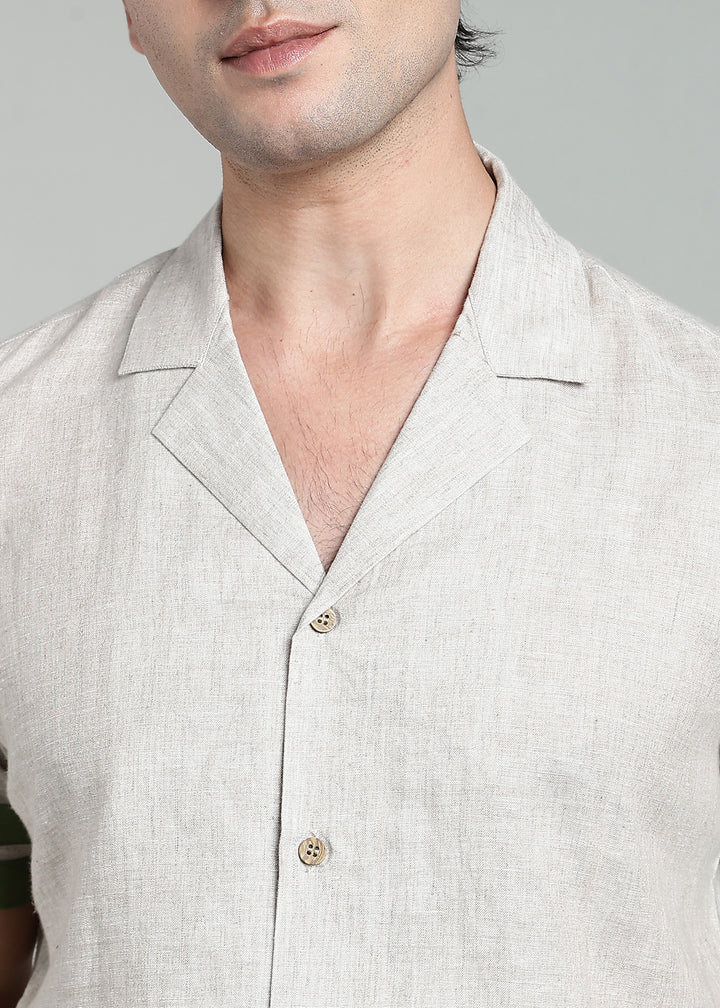 Man wearing 100% pure linen cuban-collar shirt in pure ecru with cossack-green accents in 60 LEA