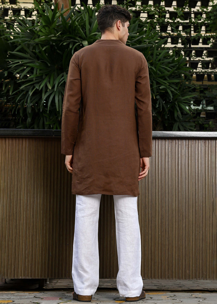 Man wearing a 100% pure linen Coffee Brown Kurta, in a green background outdoor.