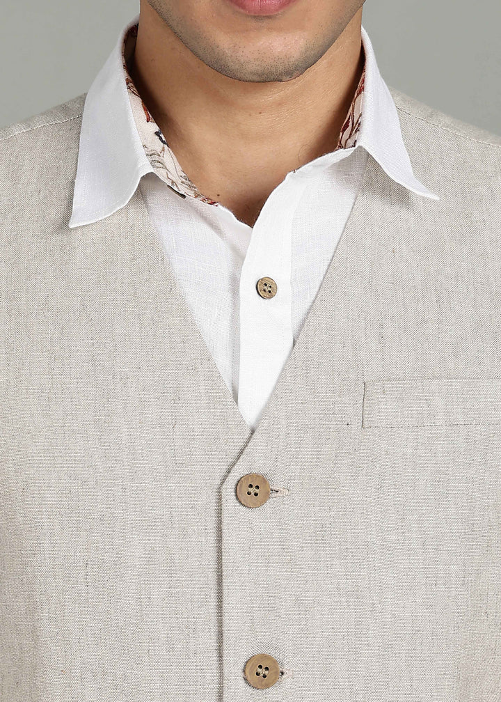 Man wearing a 100% pure linen ecru waistcoat in 25 LEA over a white shirt against a gray background