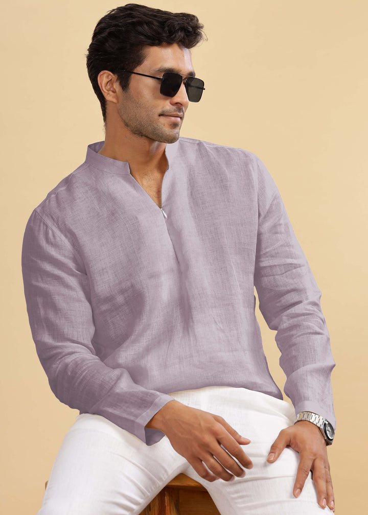 Man wearing a 100% pure linen cameo pink short kurta and white pants against a beige background