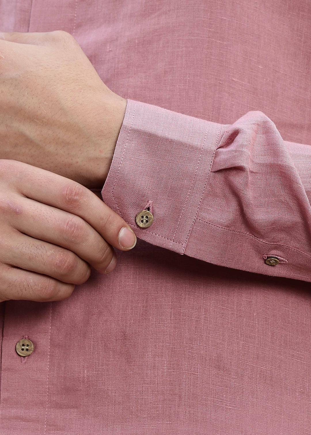 Man wearing a 100% Dusty pink yellow Kurta, in a Green outdoor Background.