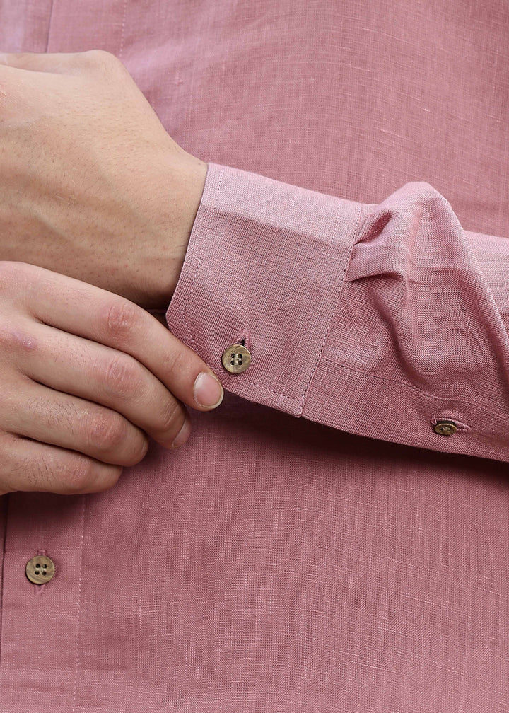 Man wearing a 100% Dusty pink yellow Kurta, in a Green outdoor Background.