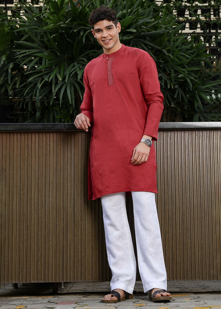 Man wearing mud red Kurta, 100% pure linen, outdoor green background.
