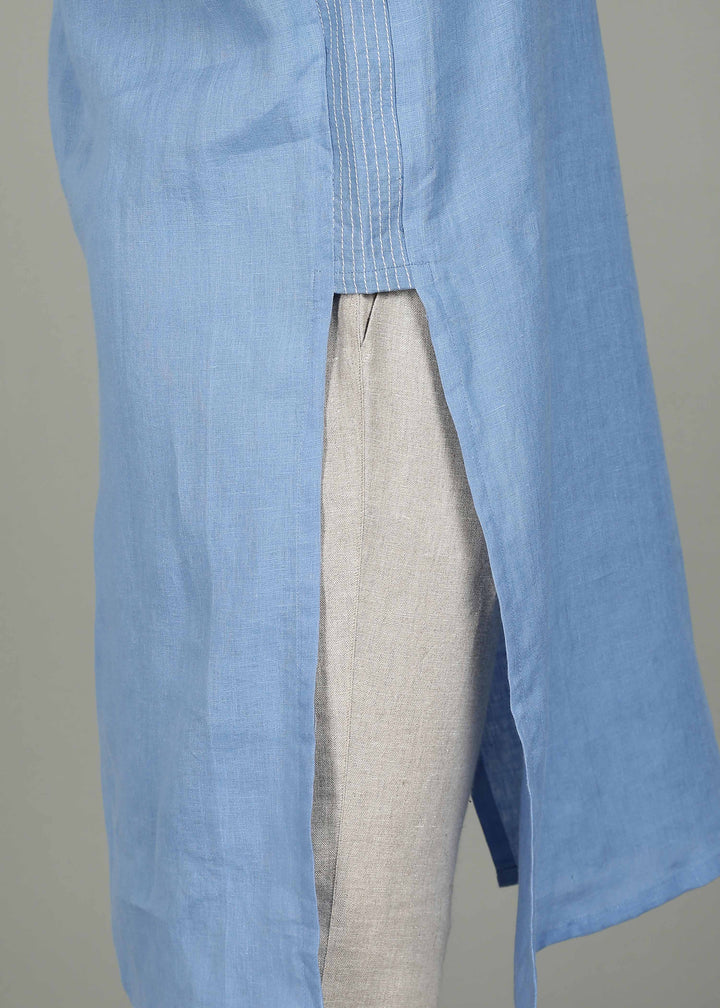 Man wearing a 100% pure linen olympic blue long kurta in 60 LEA with white detailing against a gray background