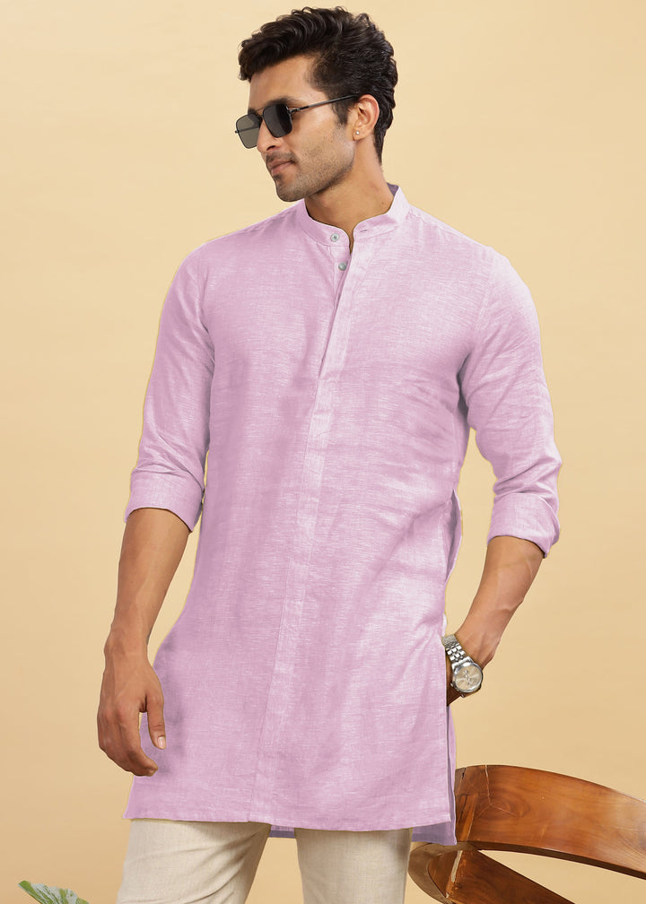 Man wearing a 100% pure linen hermosa pink kurta with beige pants against a beige background