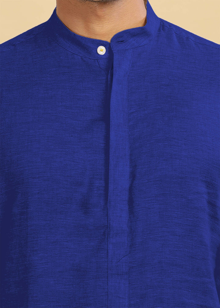 Close-up of a 100% pure linen egyptian blue kurta with a button on a beige background