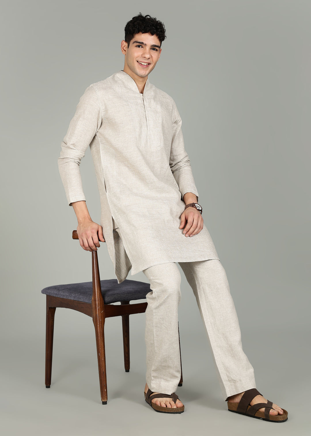 Man wearing a 100% pure linen Ecru Kurta, in a grey background indoor.
