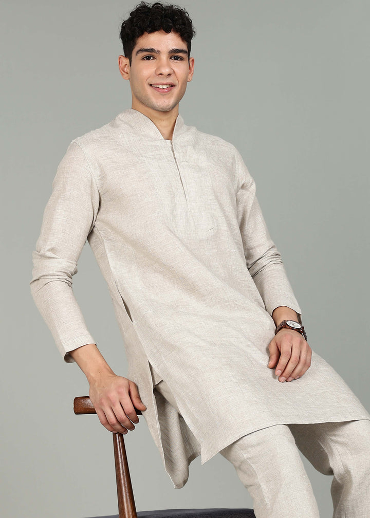 Man wearing a 100% pure linen Ecru Kurta, in a grey background indoor.
