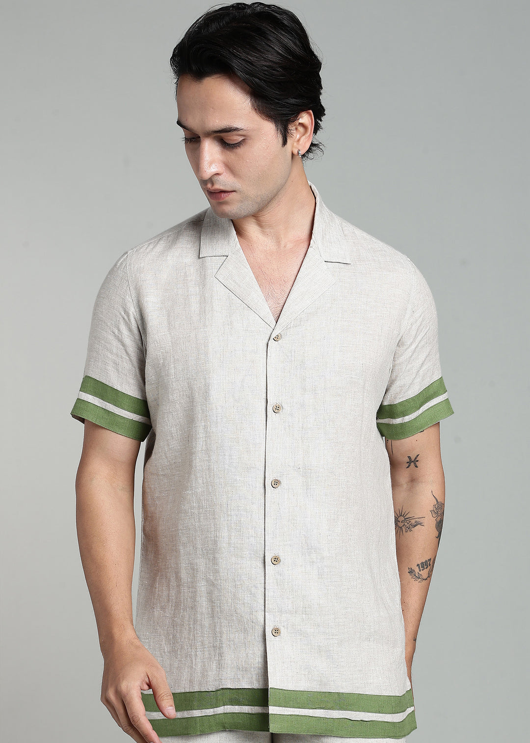 Man wearing 100% pure linen cuban-collar shirt in pure ecru with cossack-green accents in 60 LEA