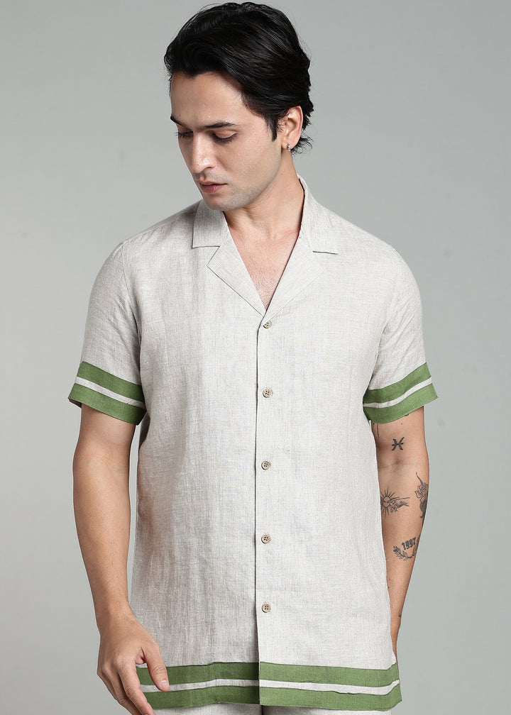 Man wearing 100% pure linen cuban-collar shirt in pure ecru with cossack-green accents in 60 LEA