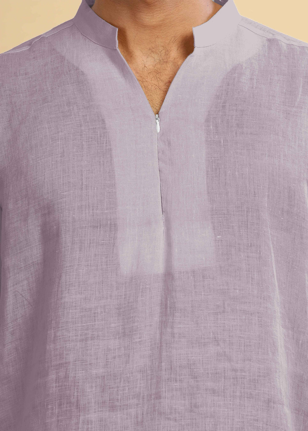 Close-up of a 100% pure linen cameo pink short kurta with a zipper on a beige background