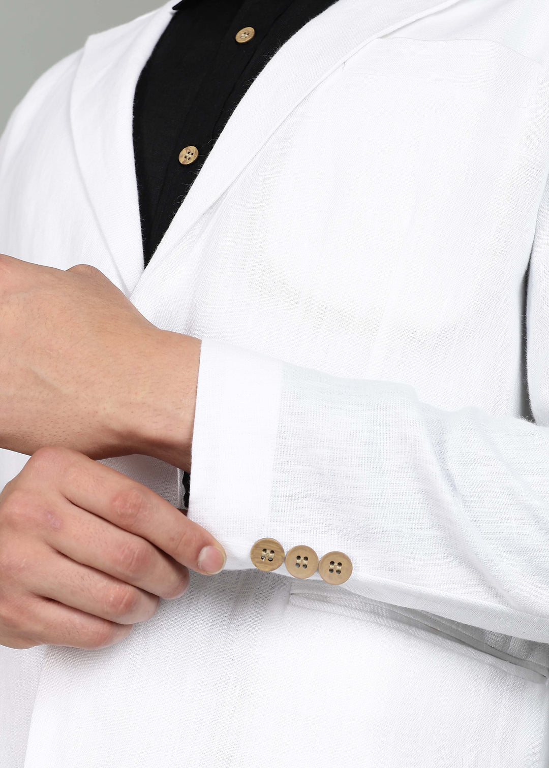 Man wearing a 100% pure linen white Jacket in 25 LEA over a black shirt on a gray background