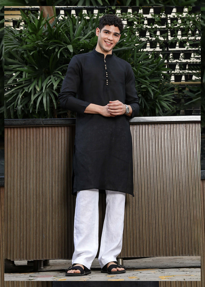 Man wearing a 100% pure linen black long kurta with pink floral design on the back in 60 LEA