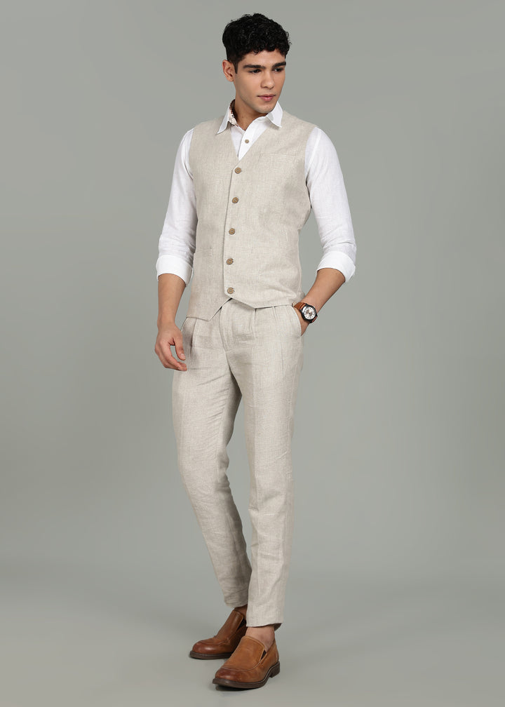 Man wearing a 100% pure linen ecru waistcoat in 25 LEA over a white shirt against a gray background