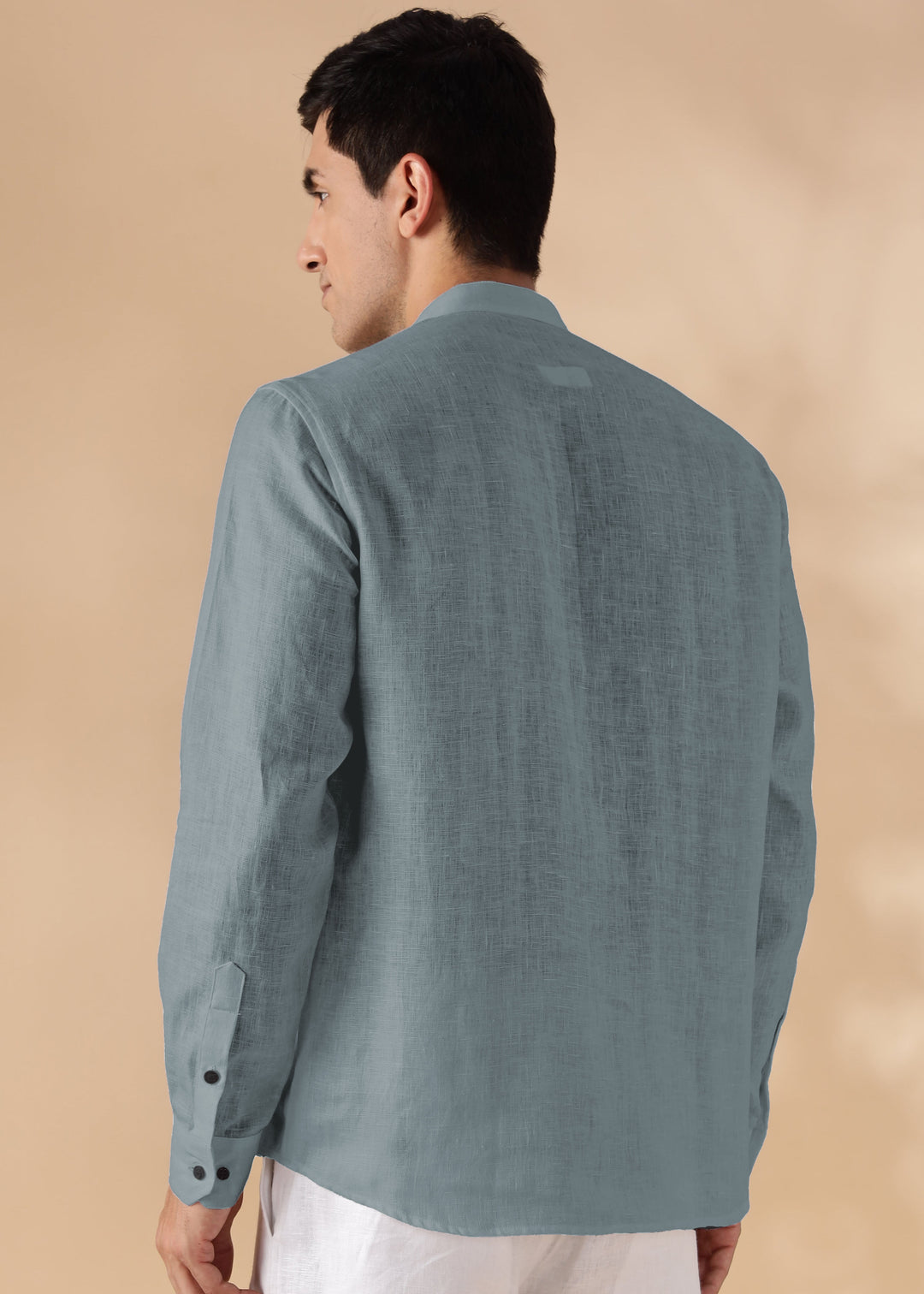 Man wearing a 100% pure linen mineral grey short kurta against a beige background