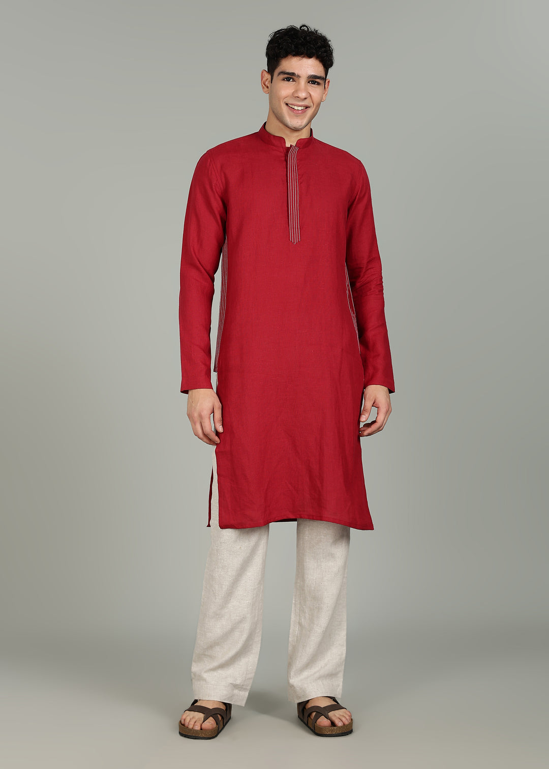 Man wearing a 100% pure linen mud red long kurta in 60 LEA with white detailing against a gray background