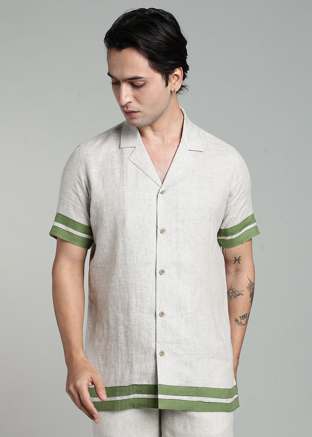 Man wearing 100% pure linen cuban-collar shirt and shorts in pure ecru with cossack-green accents in 60 LEA(shirt) & 25 LEA(shorts)