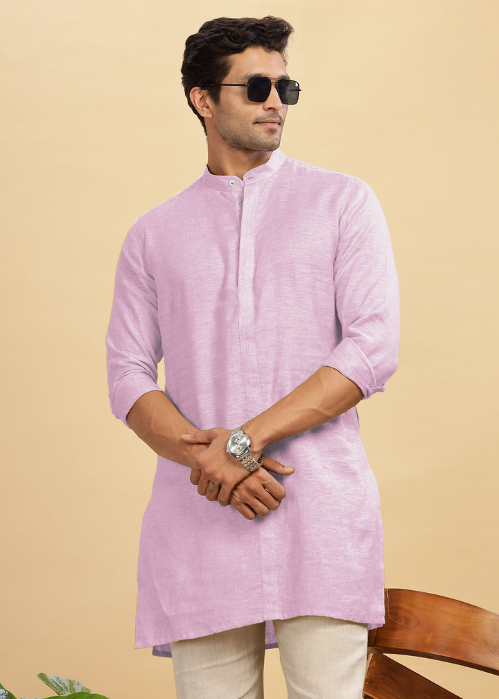 Man wearing a 100% pure linen hermosa pink kurta with beige pants on a beige background