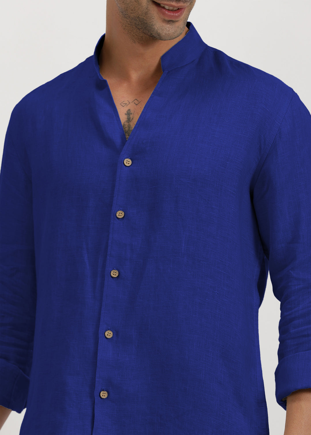 Man wearing a 100% pure linen egyptian blue shirt on a plain background