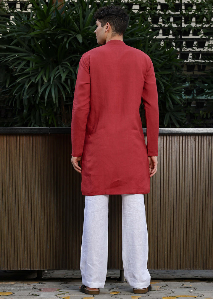 Man wearing mud red Kurta, 100% pure linen, outdoor green background.