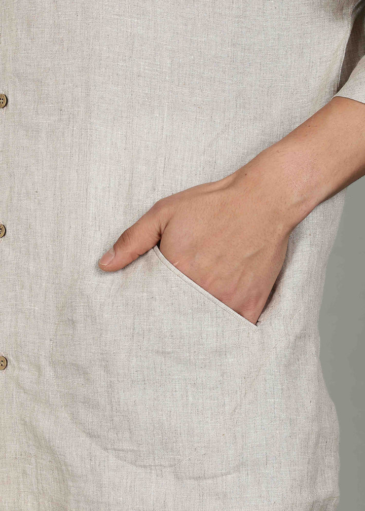 Man wearing a 100% pure linen ecru short kurta in 60 LEA with a gray background