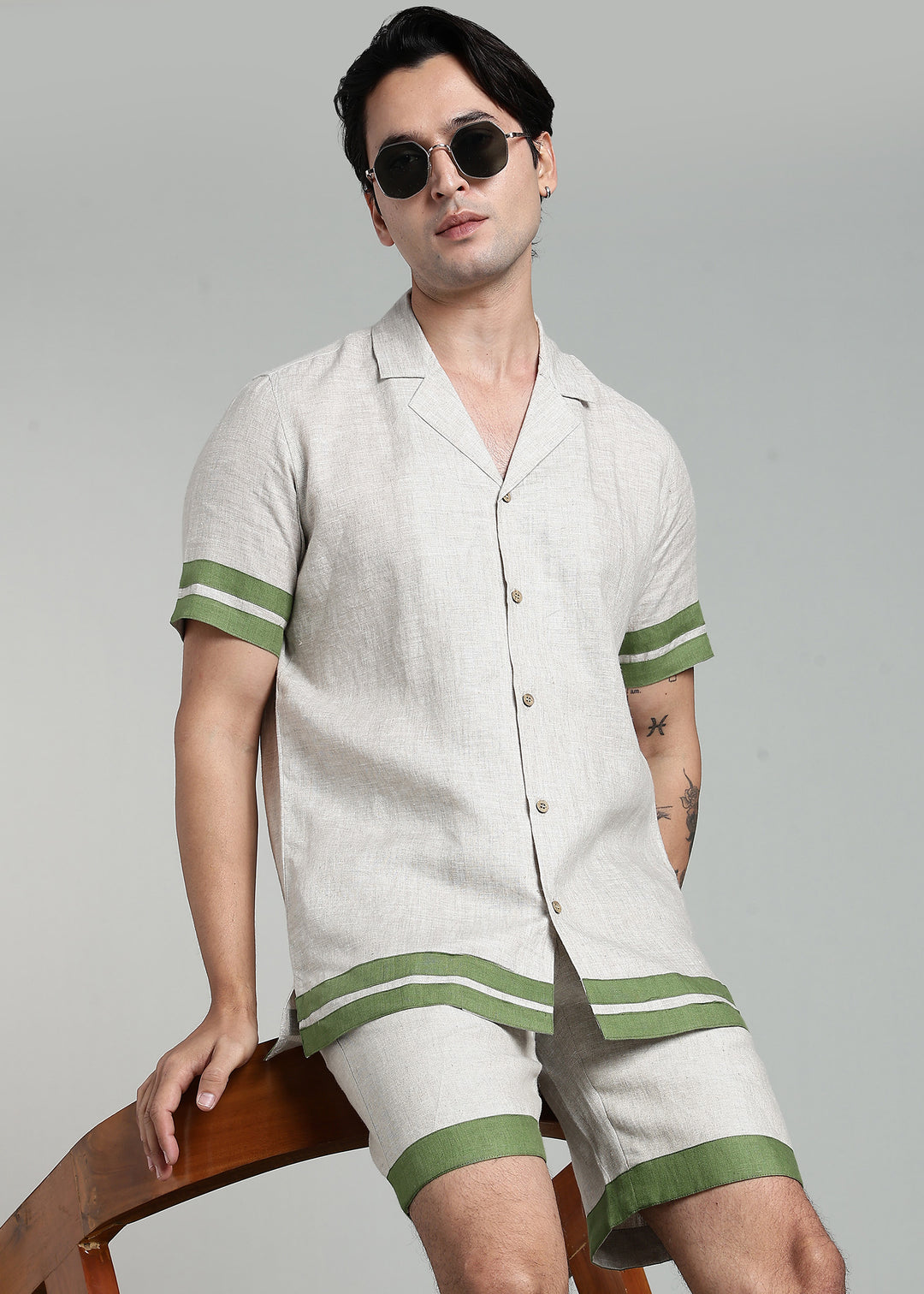 Man wearing 100% pure linen cuban-collar shirt in pure ecru with cossack-green accents in 60 LEA