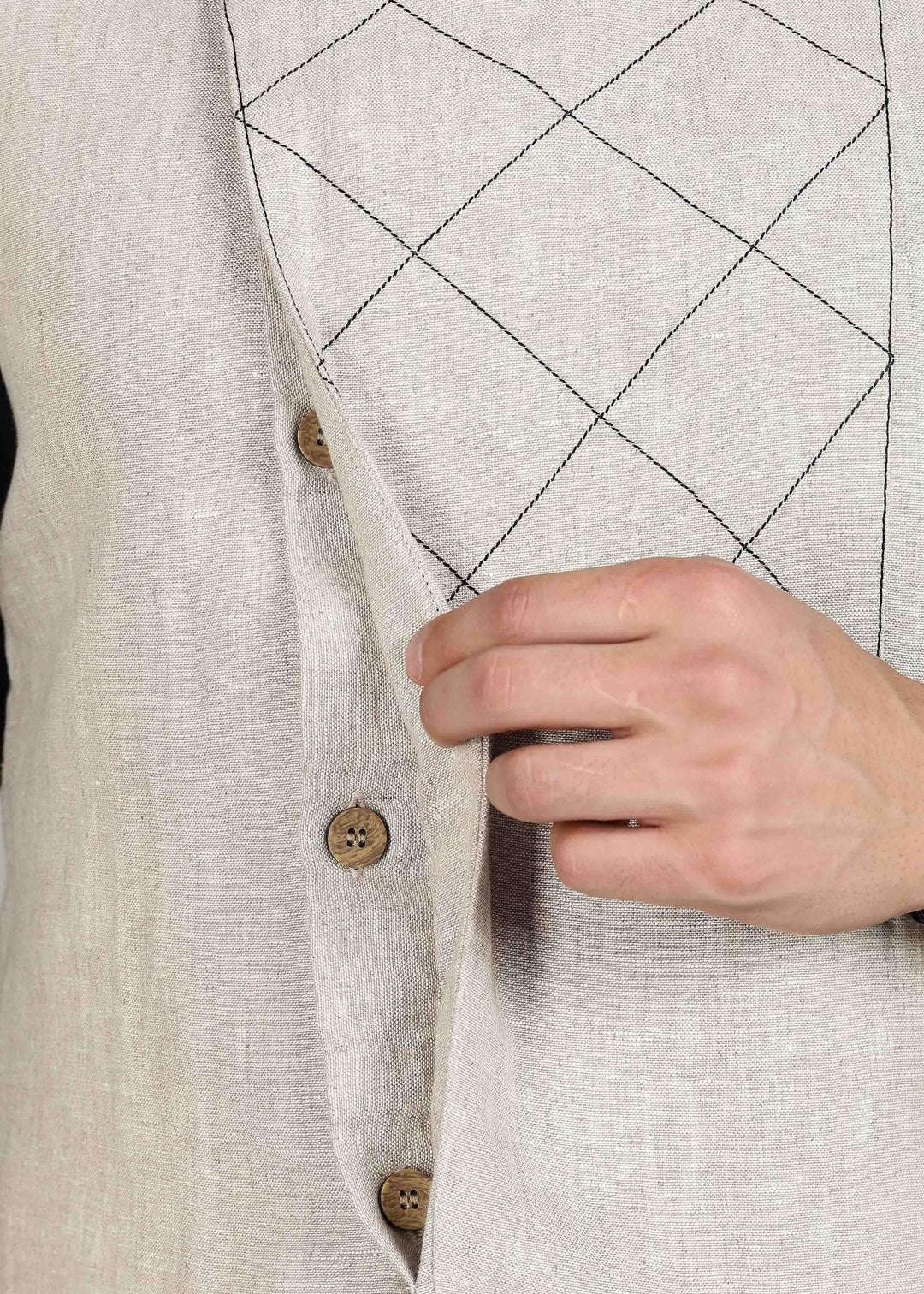 Man wearing an ecru 100% pure linen embroidered vest in 25 LEA over a black shirt on a gray background