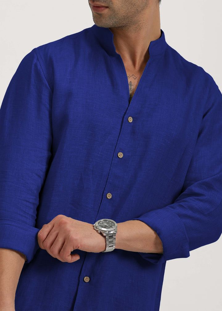 Man wearing a 100% pure linen egyptian blue shirt on a plain background