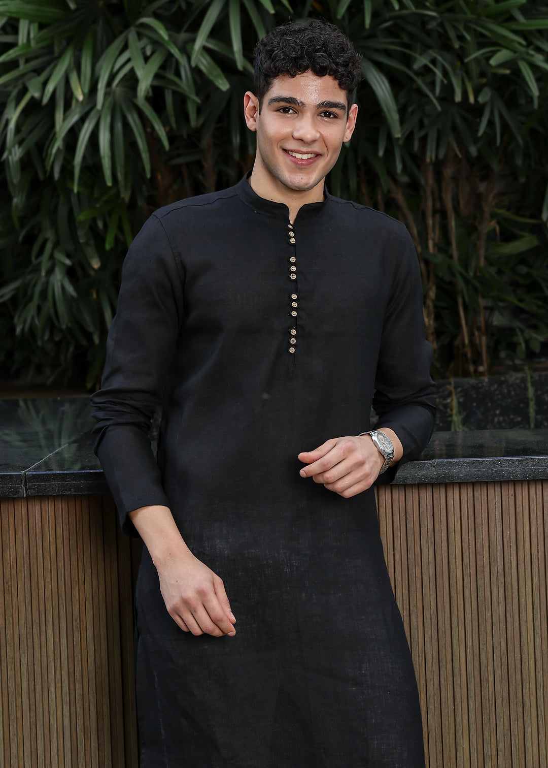 Man wearing a 100% pure linen black long kurta with pink floral design on the back in 60 LEA