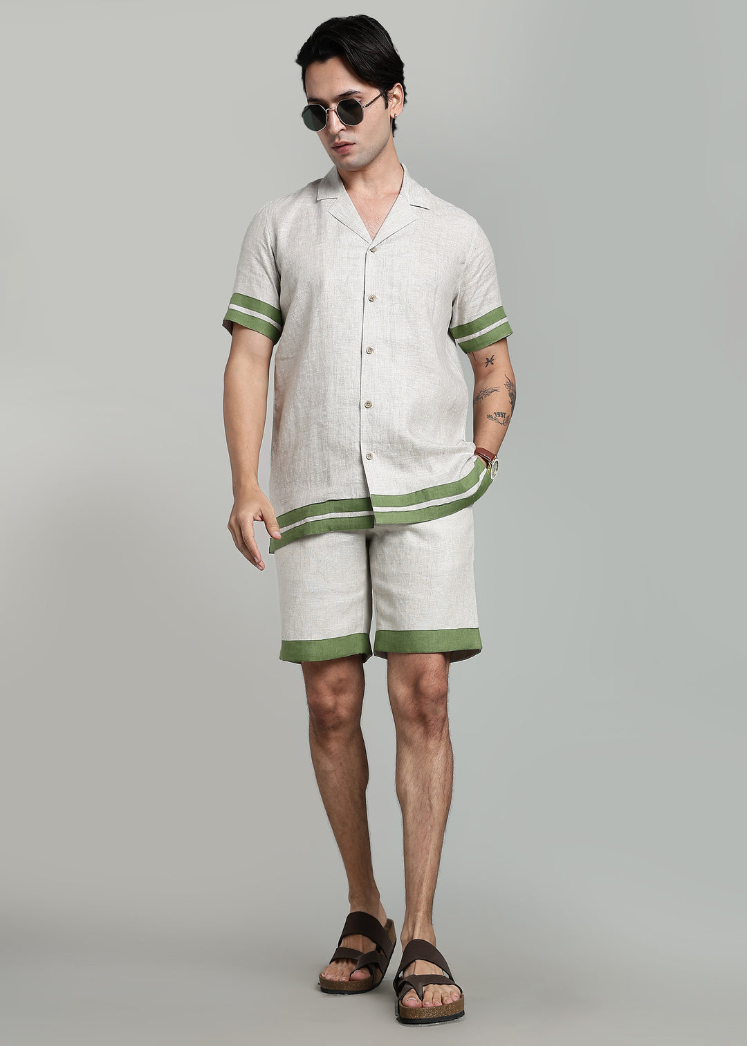 Man wearing 100% pure linen cuban-collar shirt and shorts in pure ecru with cossack-green accents in 60 LEA(shirt) & 25 LEA(shorts)