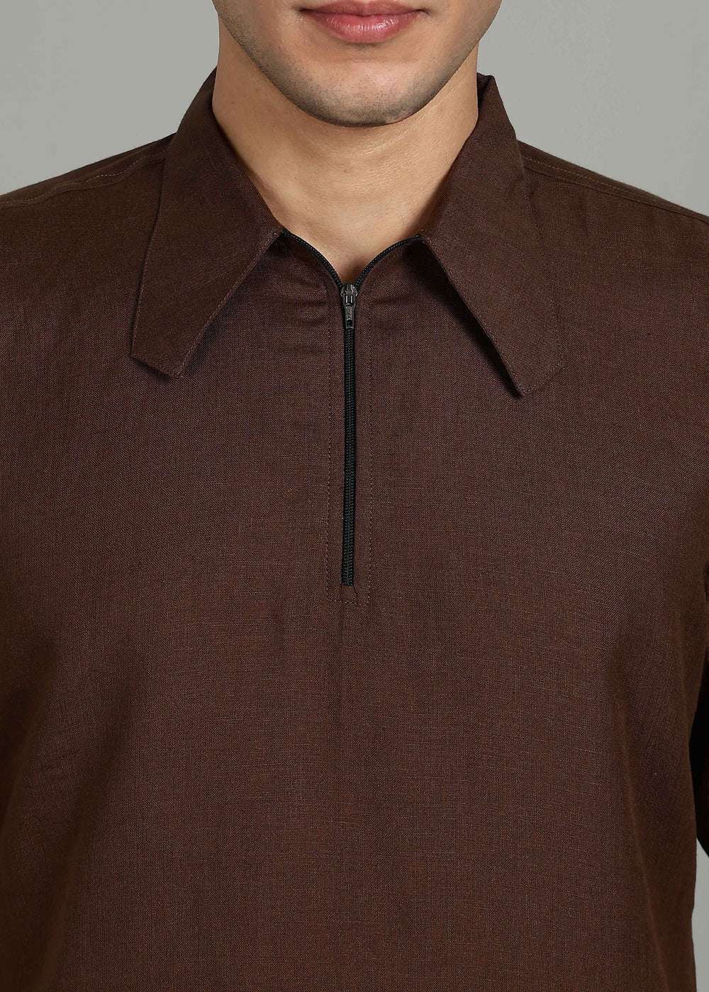 Man wearing 100% 60 LEA Linen Coffee brown T - Shirt in an indoor grey background.