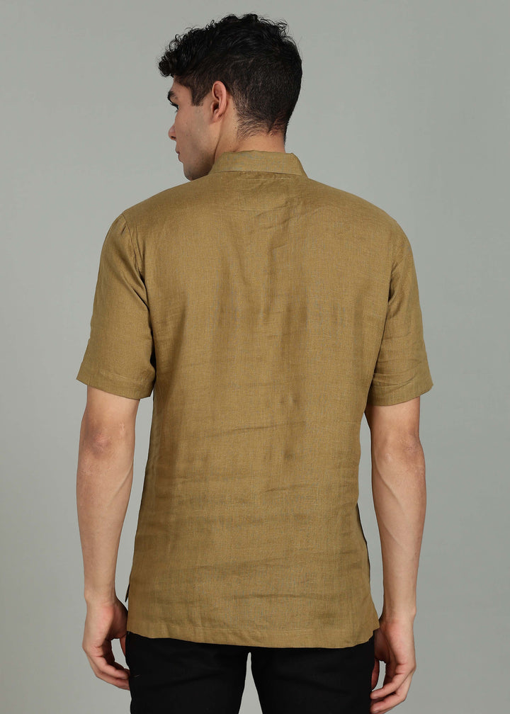 Man wearing 100% 60 LEA Linen Golden Olive Green T - Shirt in an indoor grey background.