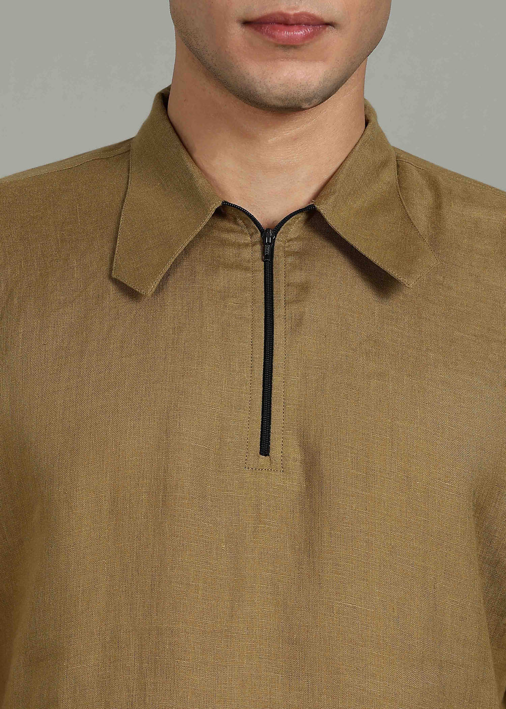 Man wearing 100% 60 LEA Linen Golden Olive Green T - Shirt in an indoor grey background.