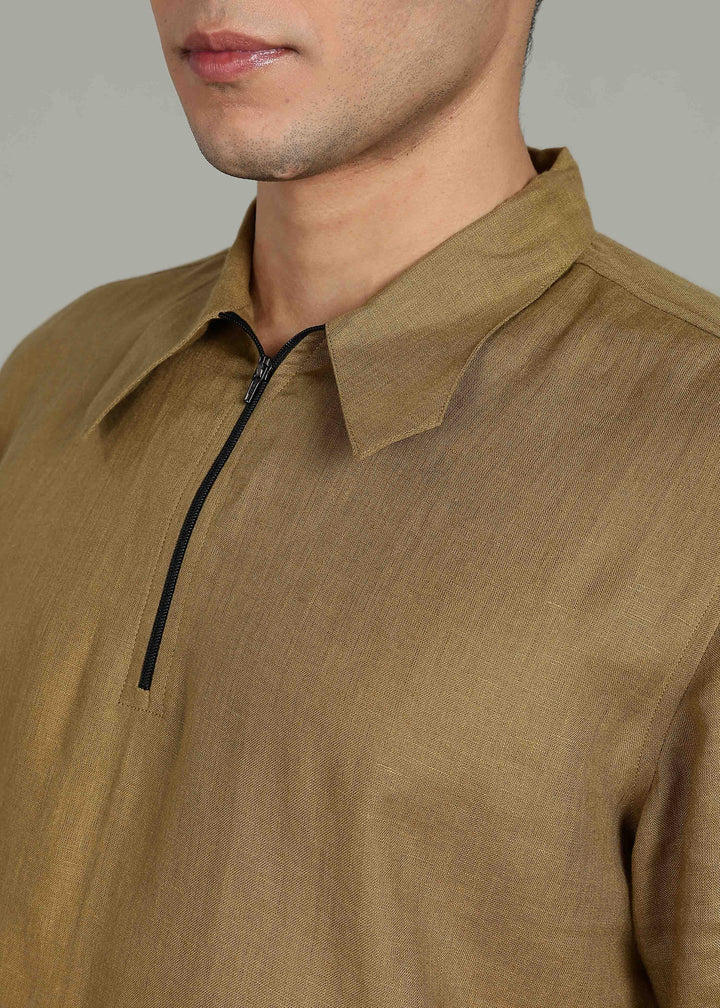 Man wearing 100% 60 LEA Linen Golden Olive Green T - Shirt in an indoor grey background.