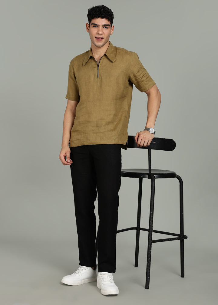 Man wearing 100% 60 LEA Linen Golden Olive Green T - Shirt in an indoor grey background.