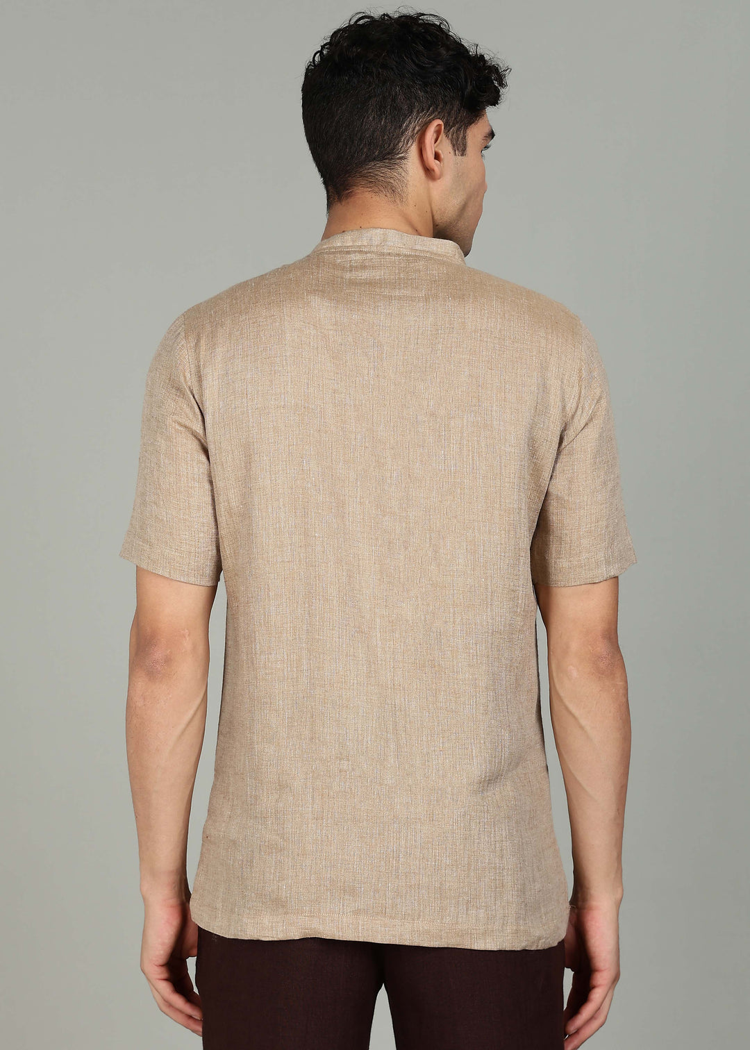 Man wearing 100% 60 LEA Mocha Mandarin collar  T - Shirt in an indoor grey background.