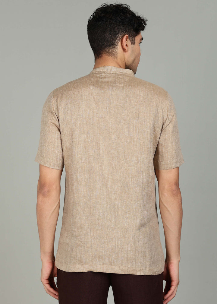 Man wearing 100% 60 LEA Mocha Mandarin collar  T - Shirt in an indoor grey background.