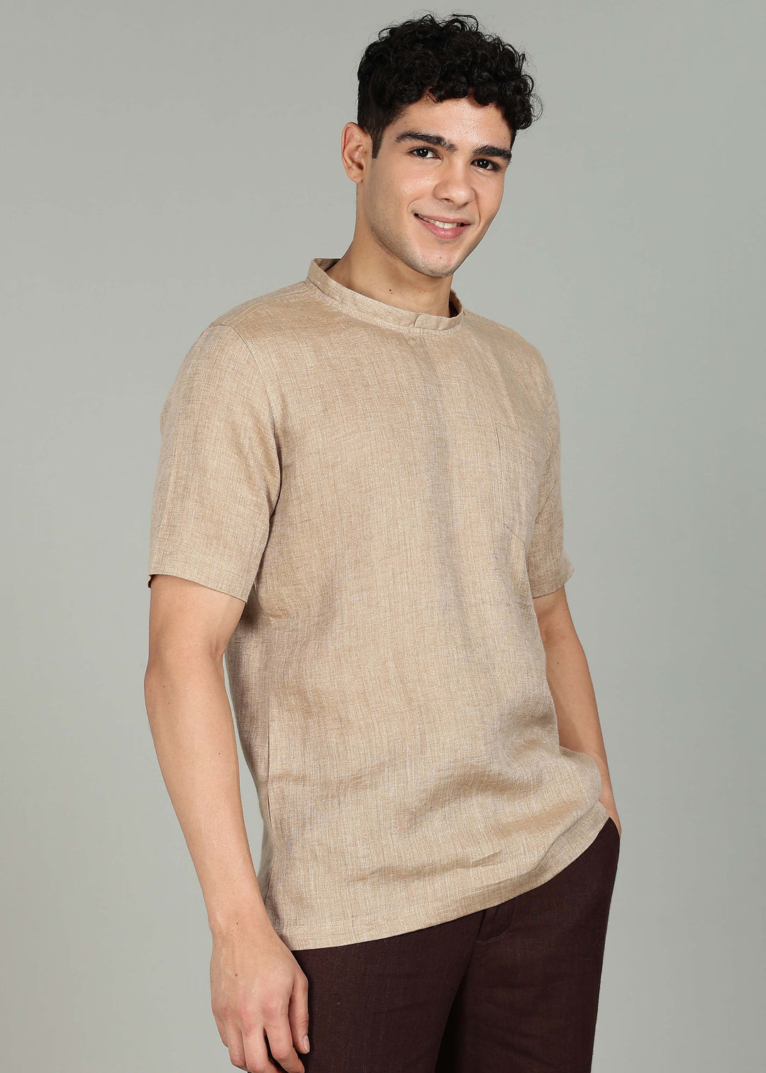 Man wearing 100% 60 LEA Mocha Mandarin collar  T - Shirt in an indoor grey background.